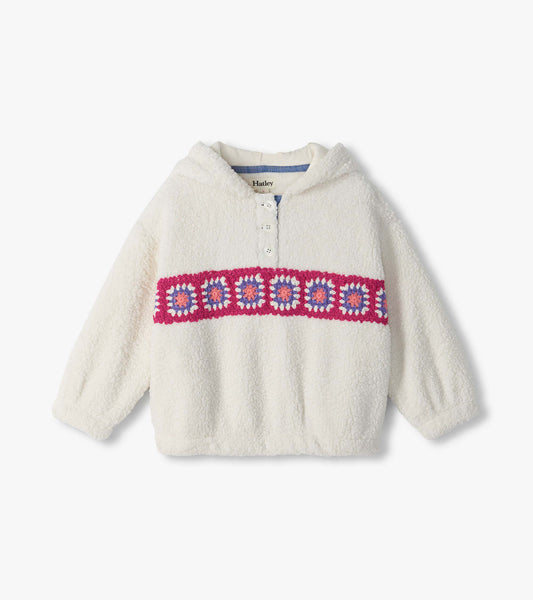 Front view of ivory pullover with half-button collar and pink, purple, and coral crochet band across chest