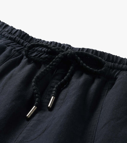 Close-up of black pants with an elastic waistband and braided drawstring tie