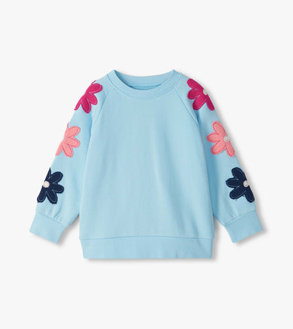 Cool blue slouchy pullover with raglan sleeves and pink, fuchsia, and navy flower appliqués
