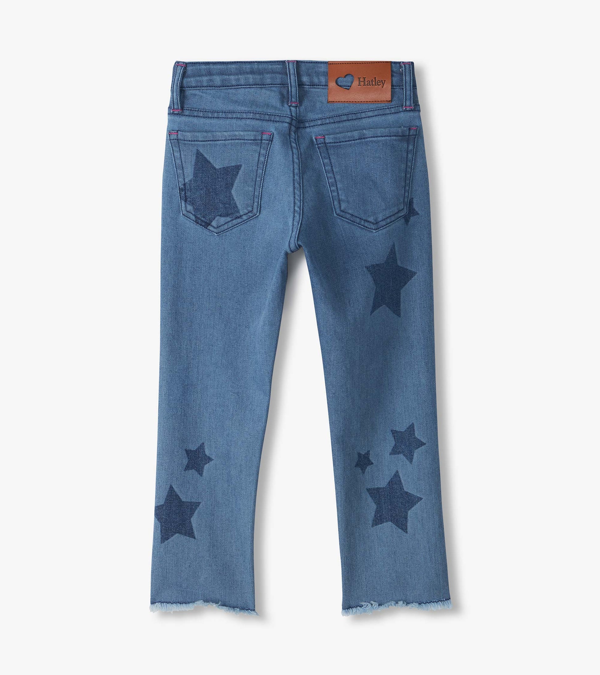 Back view of blue slouchy jeans with dark star print, back pockets, logo patch, and frayed hems