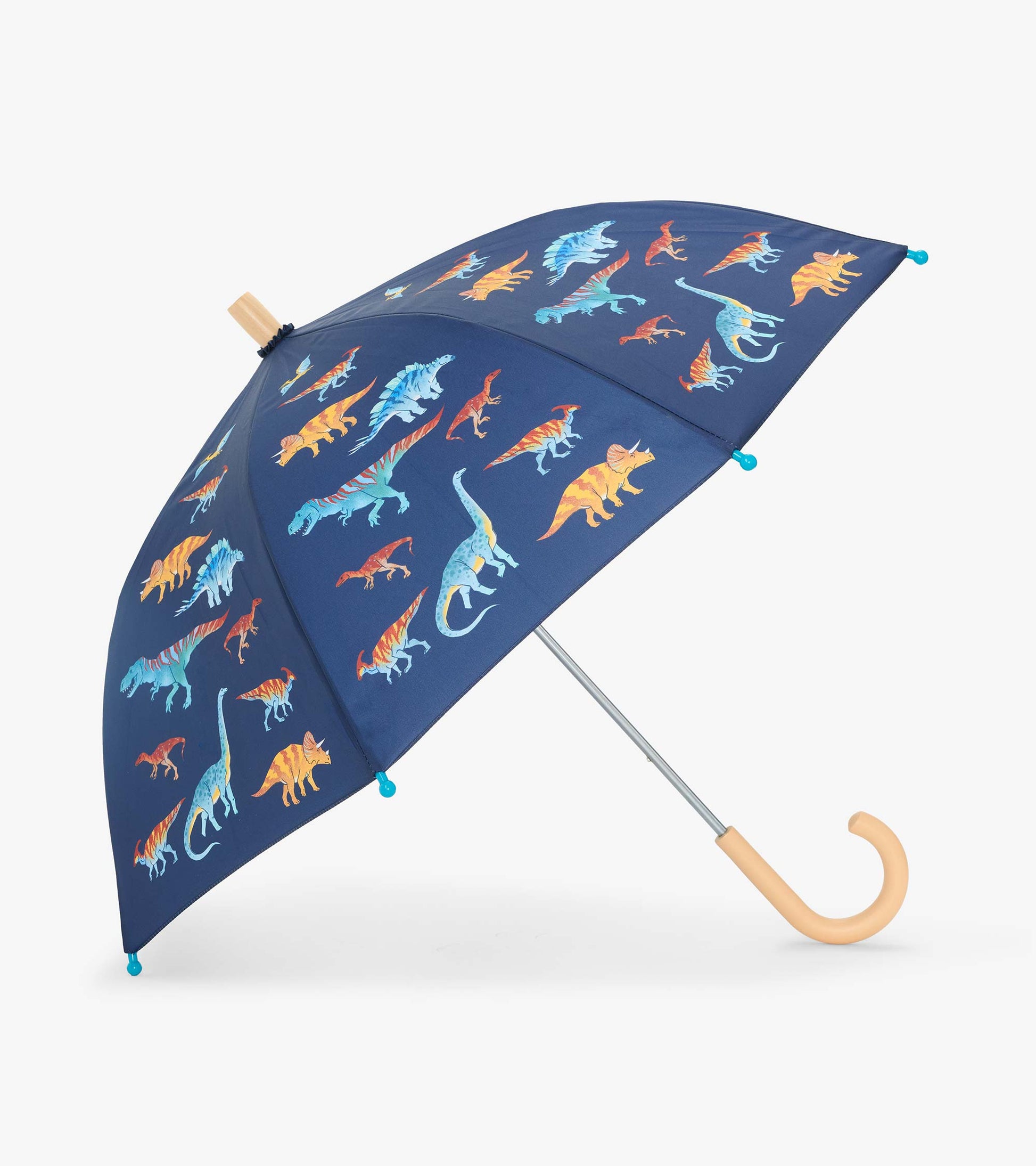 Open navy kids umbrella with colorful dinosaur print and curved light wood handle