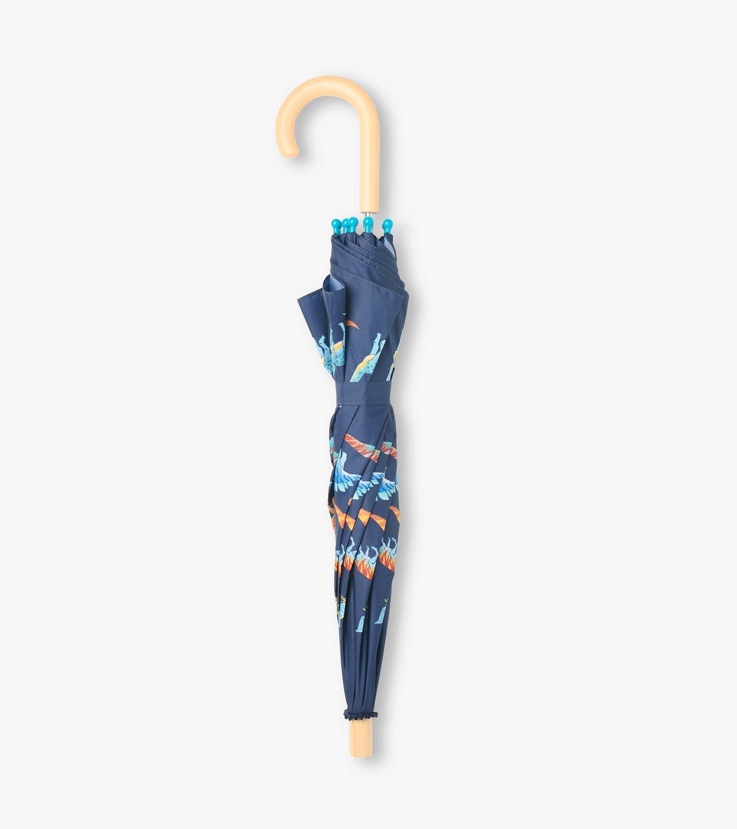 Closed navy umbrella with colorful dinosaur print, blue rounded tips, and curved light wood handle