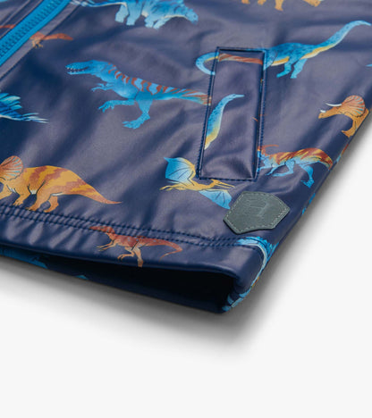 Close-up of lower front rain coat showing pocket flap, dinosaur print and small shield patch