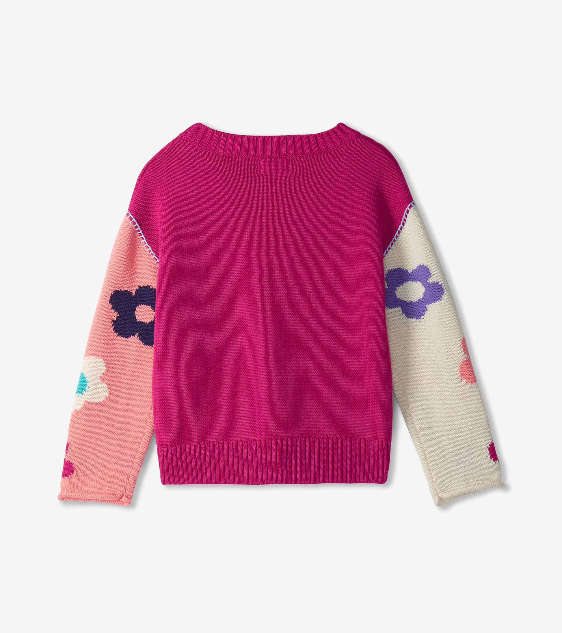 Back view of girls slouchy sweater in bright pink with floral colorblock sleeves and ribbed hem