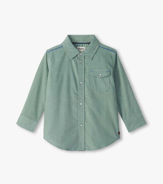 Kids green button-down shirt with long sleeves, chest pocket, snap buttons, and blue shoulder stitching