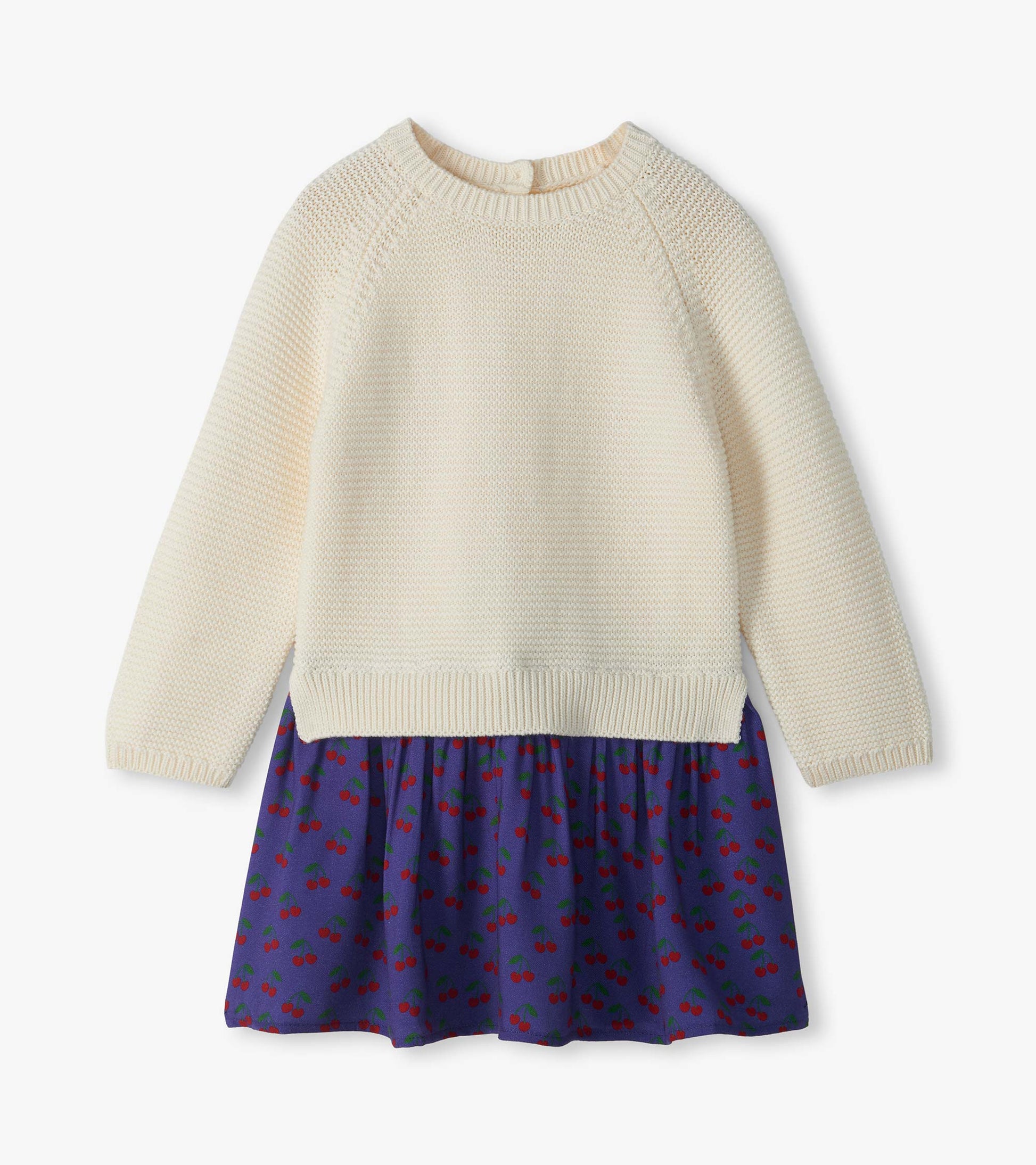 Front view of girls sweater dress with cream knit top and purple skirt with red cherry print