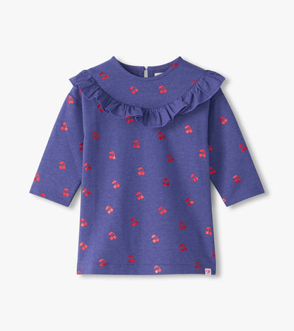 Front view of purple long sleeve dress with red cherry print and ruffle yoke