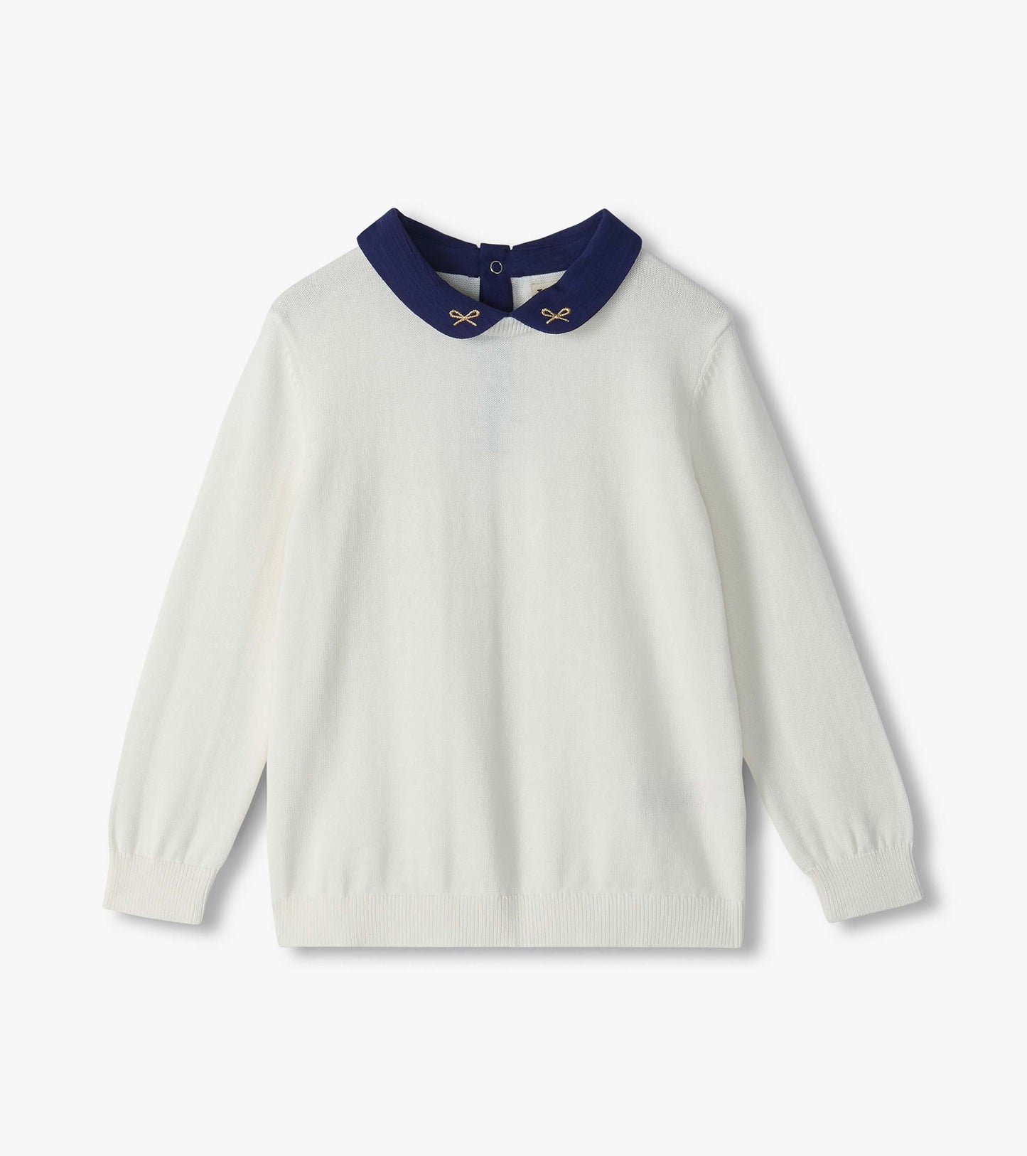 Cream sweater with long sleeves and a navy Peter Pan collar with small embroidered bows
