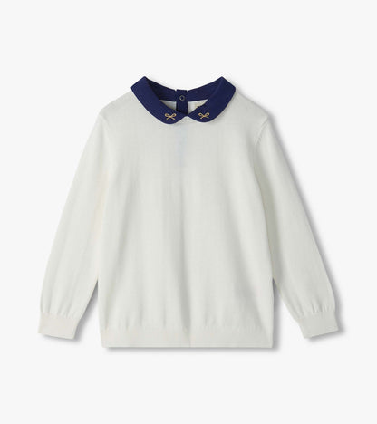 Cream girls sweater with long sleeves and navy Peter Pan collar embroidered with small gold bows