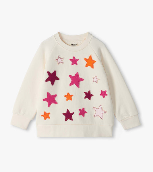 Cream slouchy pullover sweatshirt with colorful star appliqués on the front and long sleeves