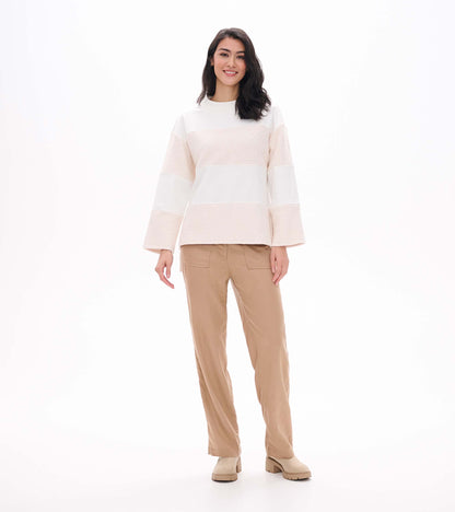 Full front view of oatmeal long sleeve top with wide sleeves and horizontal textured paneling