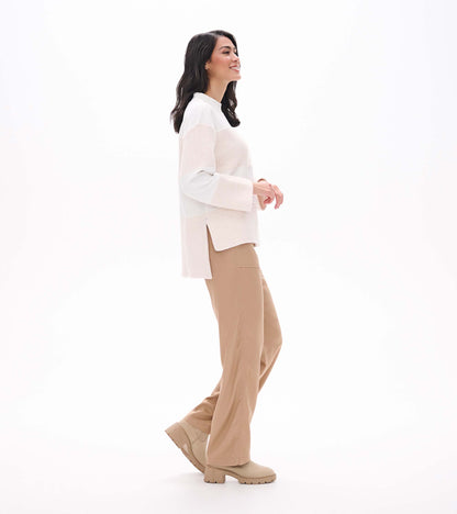 Side view of oatmeal long sleeve top showing relaxed fit, wide sleeves, and side slit hem
