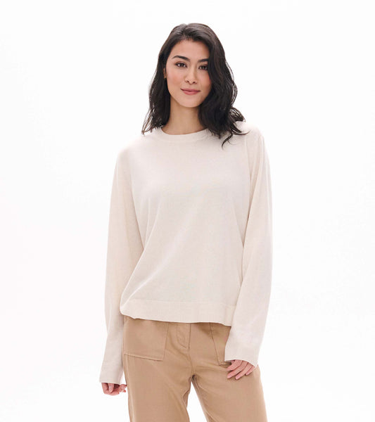 Cream melange boyfriend sweater on model, front view with crew neck and ribbed hem and cuffs