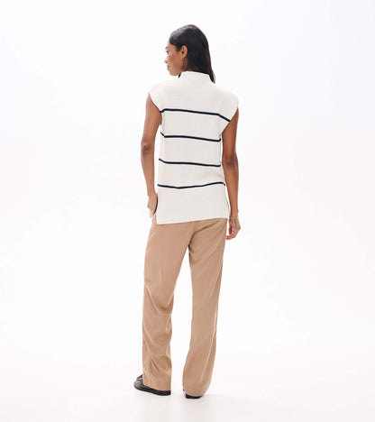 Back view of cream sleeveless sweater tunic with navy horizontal stripes on model