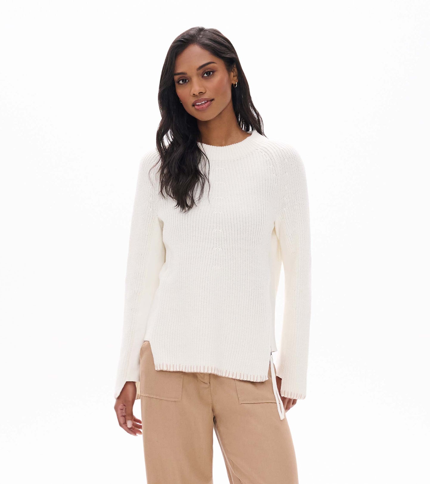 Front view of cream raglan sweater with crew neck and side zip hem detail