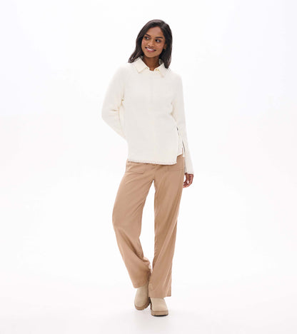 Front view of cream raglan sweater styled over a collared shirt with side zip detail