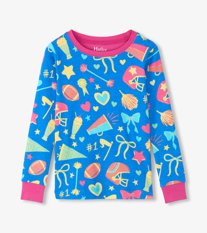 Girls pajama top in bright blue with pink neckline and cuffs, covered in cheer and football themed icons