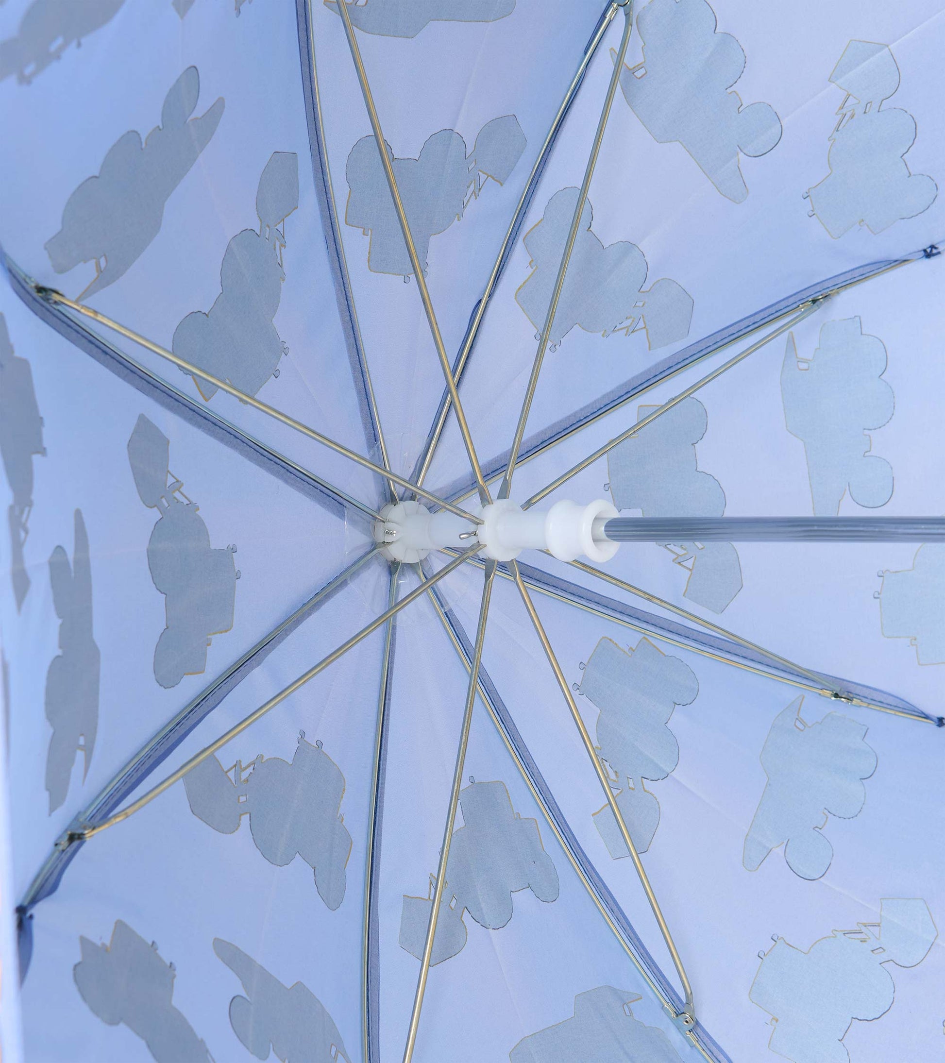 Interior view of blue umbrella showing metal ribs and pale construction vehicle silhouettes