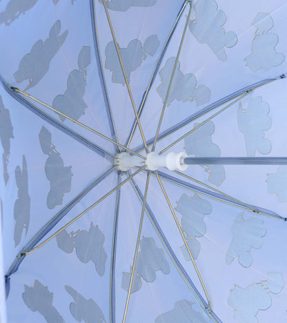 Interior view of blue umbrella showing metal ribs and pale construction vehicle silhouettes