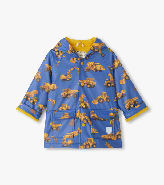 Front view of blue hooded snap rain coat with yellow lining and construction truck print
