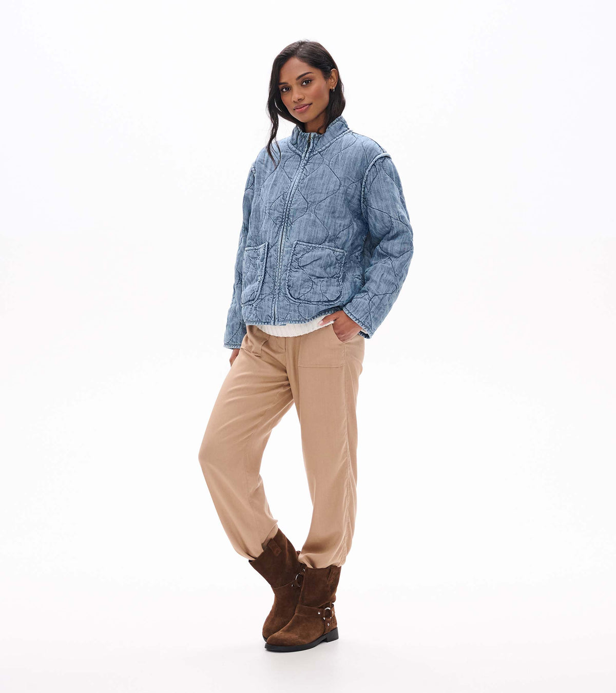 Three-quarter front view of blue acid rinse quilted jacket with stand collar and patch pockets