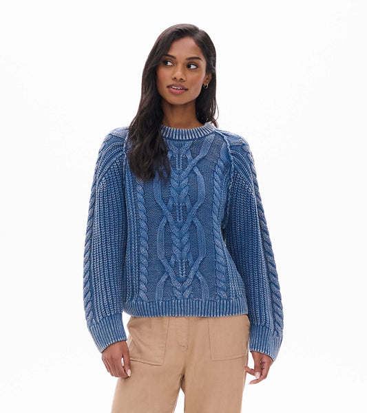 Stellar blue cable knit sweater with a crew neck, shown front view on model