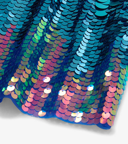 Close-up of blue and iridescent pink-purple sequins on the girls dress