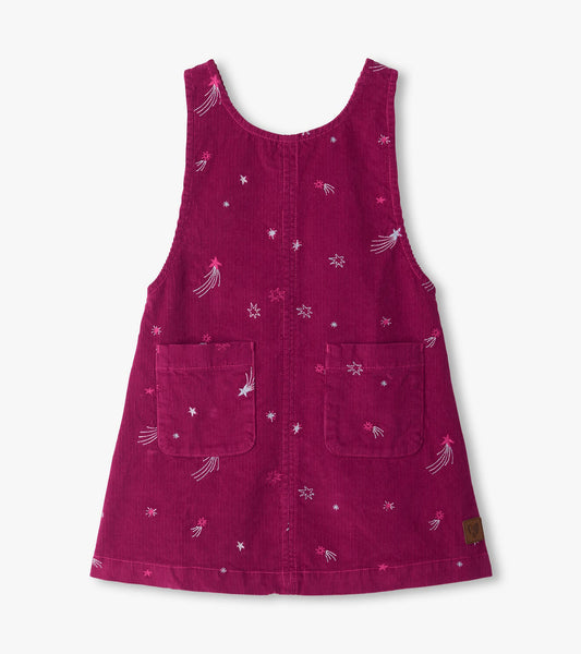 Front view of magenta pinafore dress with embroidered stars and shooting stars and two front patch pockets