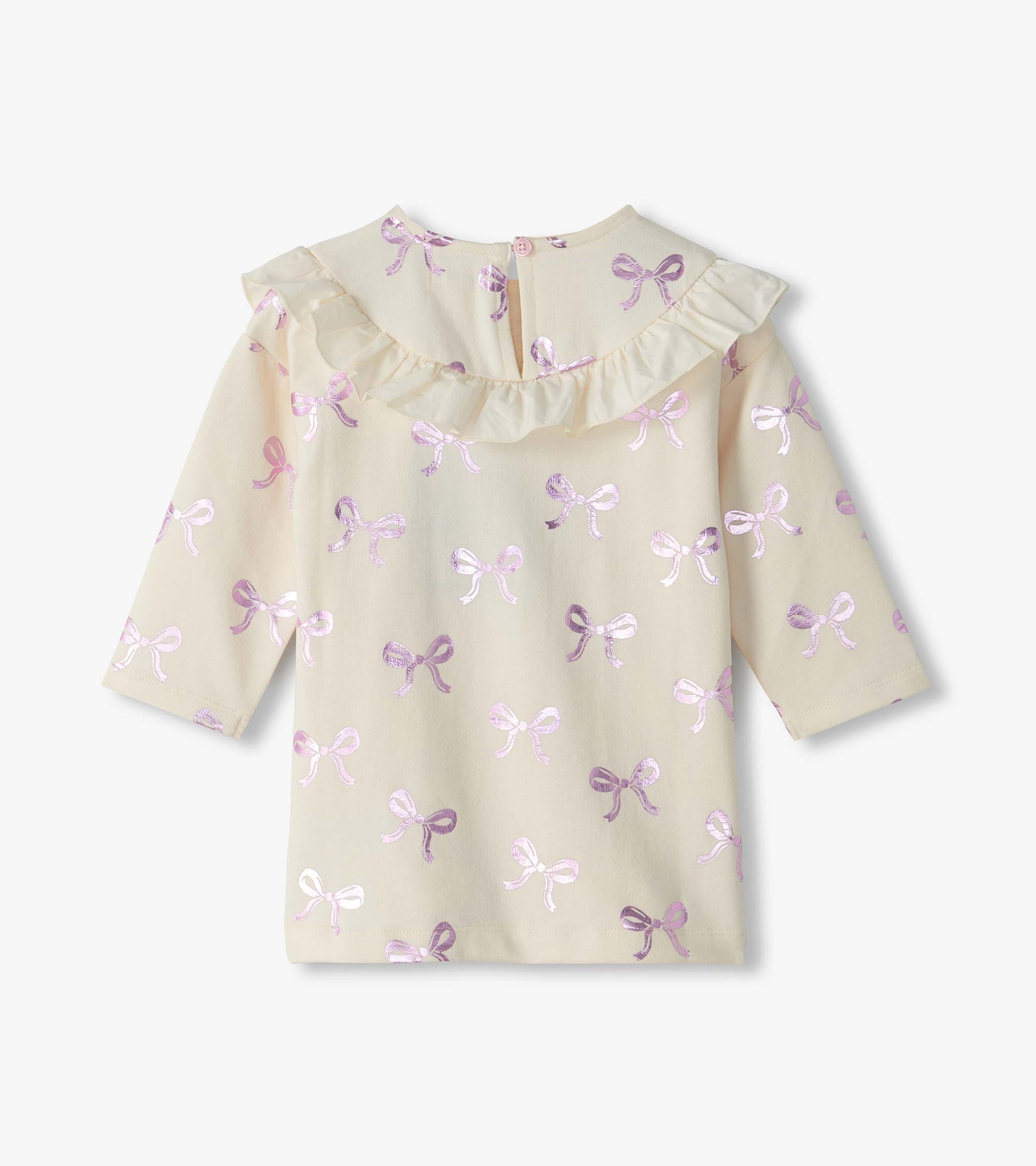 Back view of cream infant dress with pink foil bow print, ruffle yoke, long sleeves, and button closure