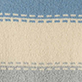 Close-up of beige textured fabric with blue stitched border bands at the top and bottom
