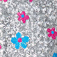 Blue and pink flower shapes on a silver glitter background