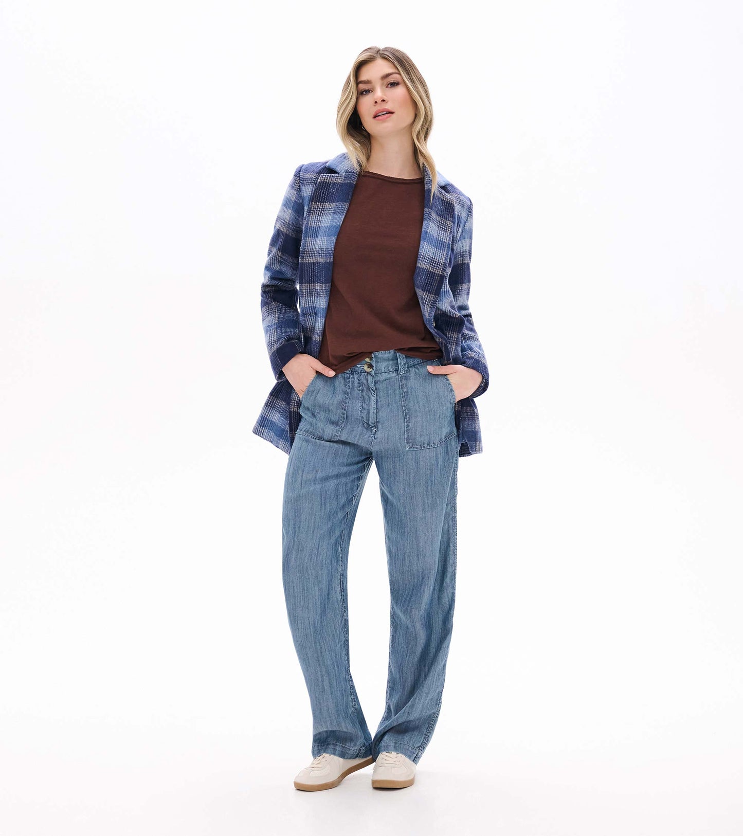 Brown raglan sleeve tee styled under a blue plaid jacket with light blue wide-leg pants