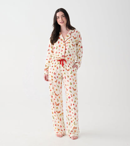 Women's cream pajama set with red piping and colorful fall print, shown from the front on a model