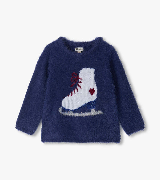 Blue fuzzy kids sweater with long sleeves and a large white figure skate graphic on the front