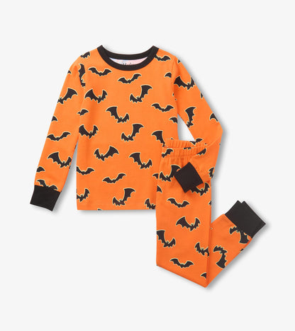 Orange kids pajama set with black bat print, long sleeve top and matching pants with black cuffs