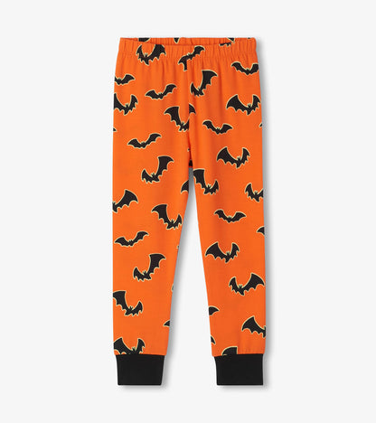 Orange pajama pants with black bat print, elastic waist, and black ankle cuffs