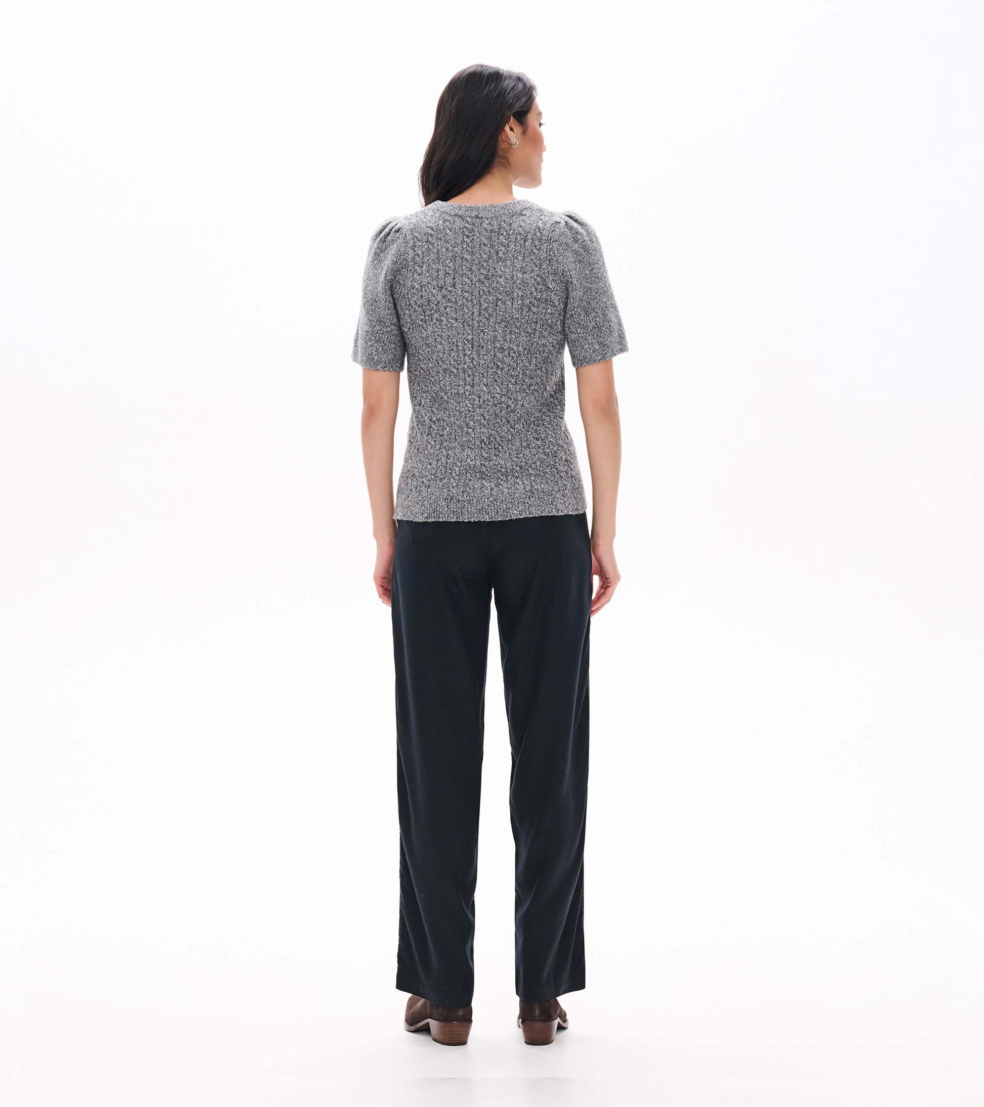 Back view of grey boucle sweater with short puff sleeves and a fitted ribbed silhouette