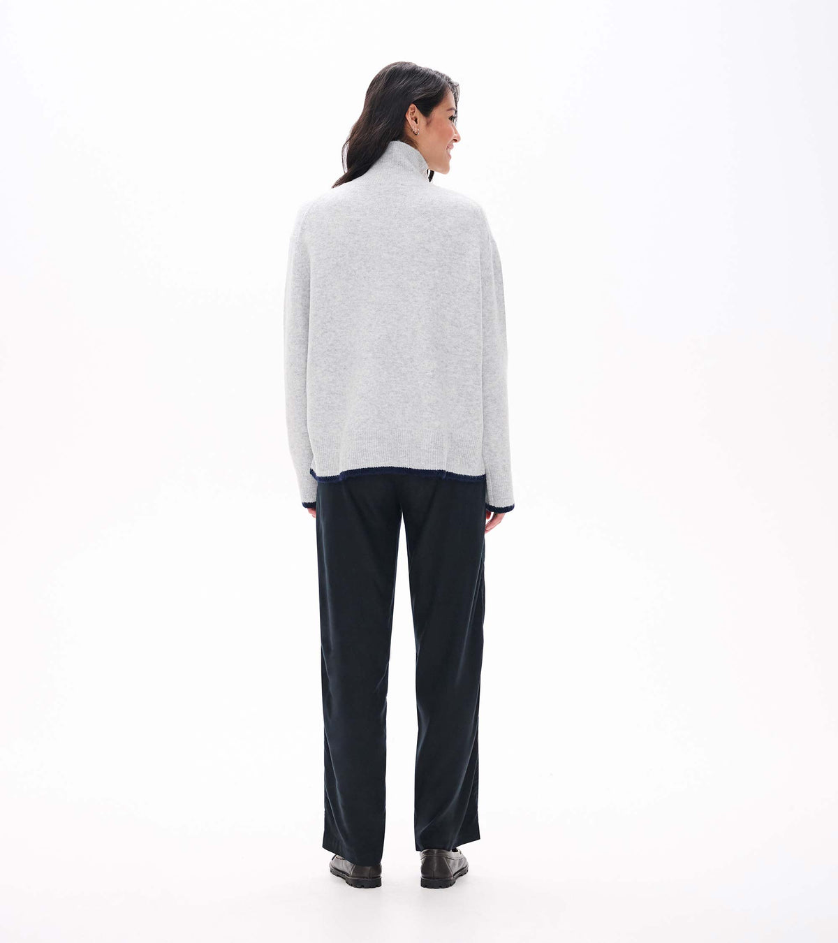 Back view of athletic grey mock neck sweater with relaxed fit and navy trim at hem and cuffs