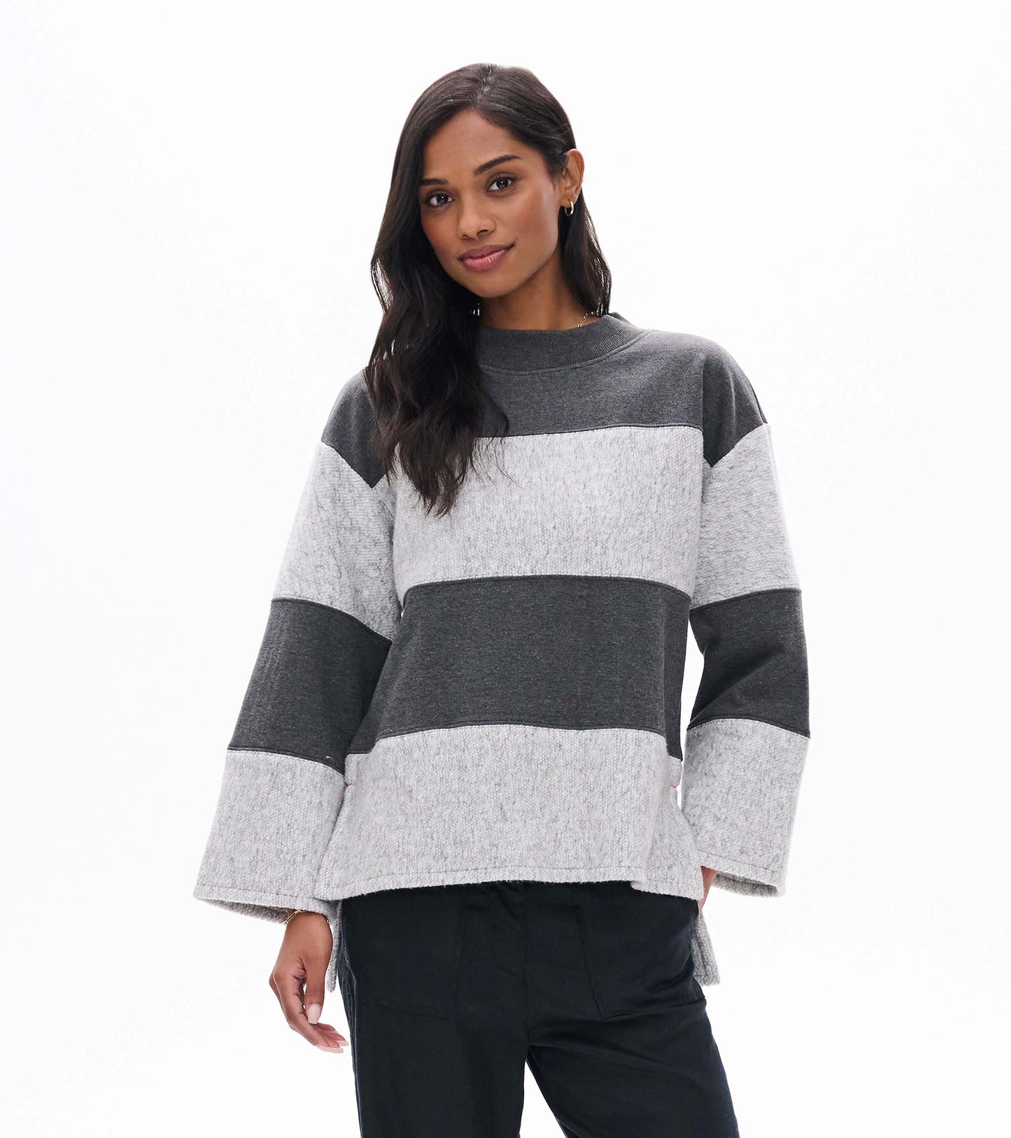 Front view of charcoal and light gray striped long sleeve top with wide sleeves and mock neck