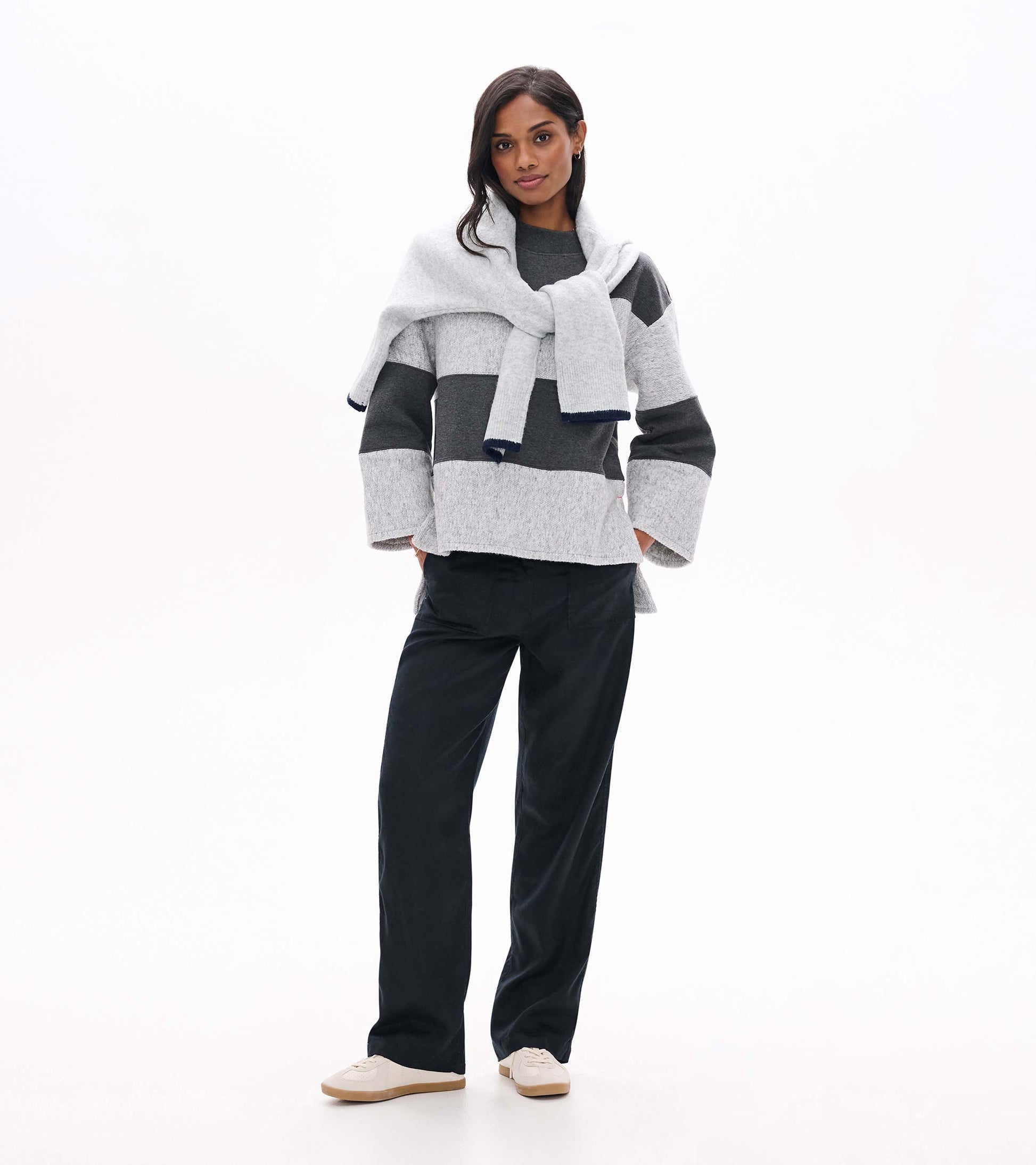 Front view of charcoal and light gray striped long sleeve top with wide cuffs and relaxed fit