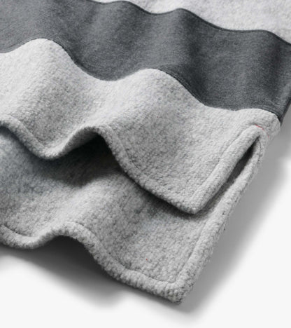 Close-up of the top showing charcoal and light gray stripes with textured fabric and wavy seams