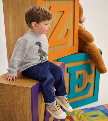 Toddler wearing a heather gray crew neck sweater with a black Labrador graphic on the front
