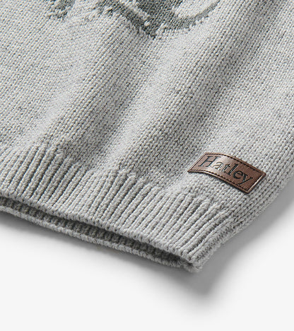 Close-up of the sweater hem with ribbed trim and a small Hatley patch