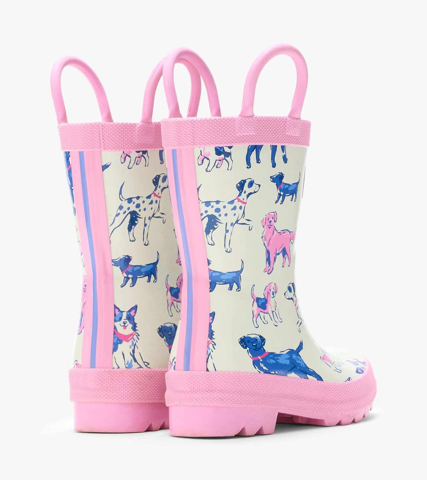 Rear angled view of cream rain boots with pink handles and trim and blue and pink dog print