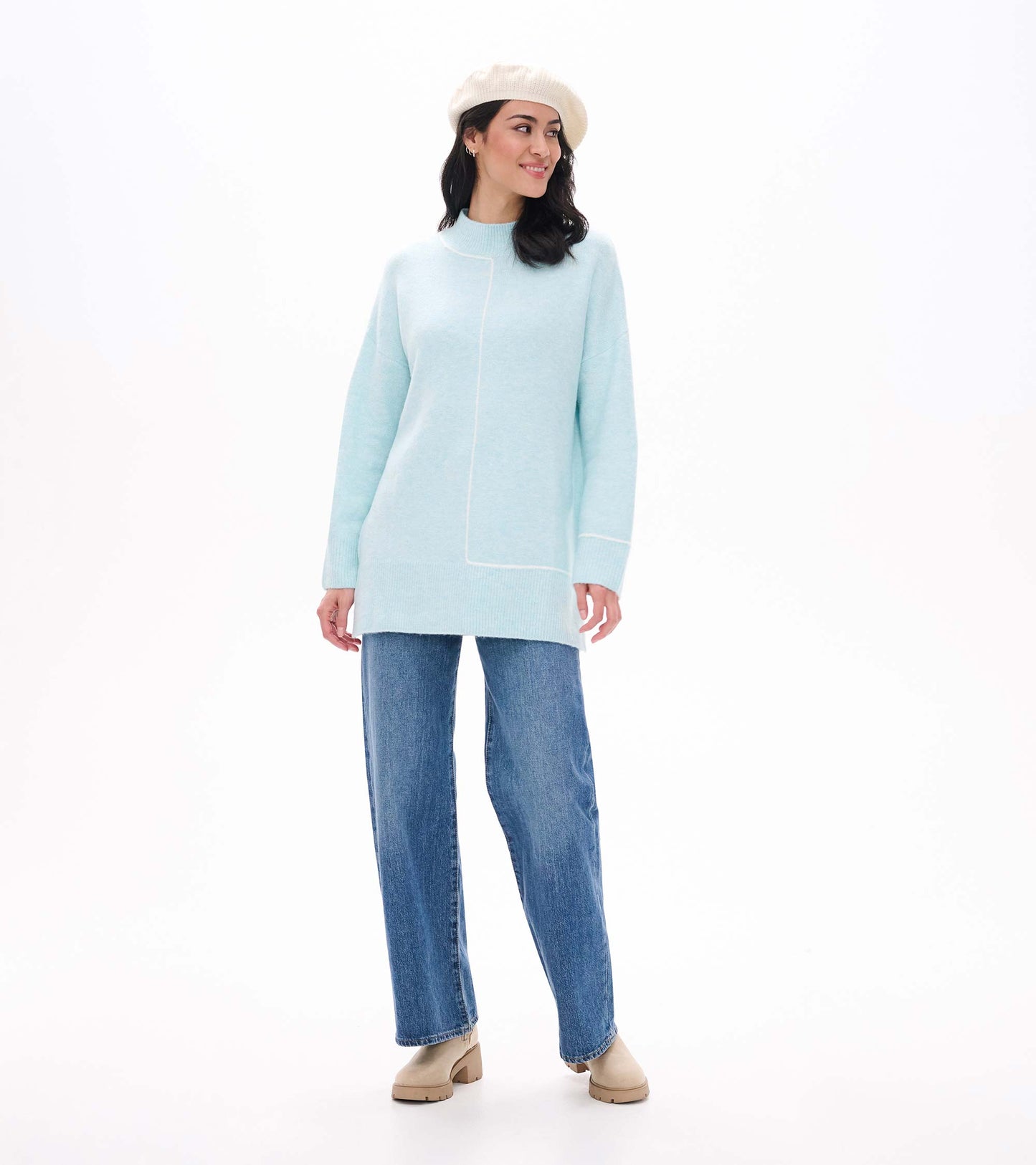 Front view of teal tunic sweater styled with jeans, boots and a cream beret