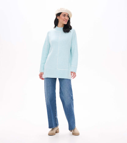Front view of teal tunic sweater styled with jeans, boots and a cream beret