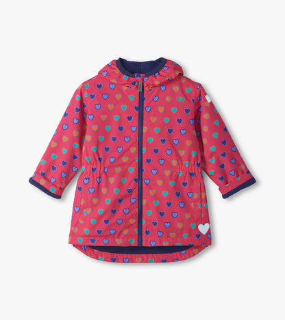 Front view of pink kids field jacket with blue, teal, and orange heart print, hood, zipper, and side pockets