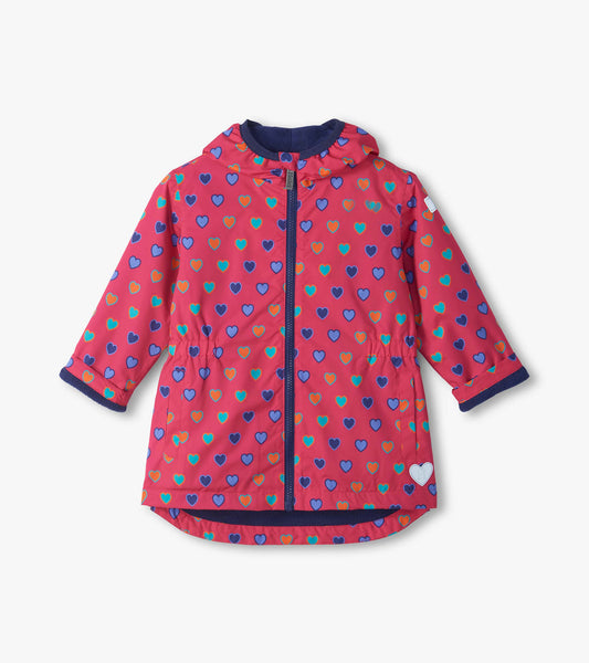 Front view of pink kids field jacket with blue, teal, and orange heart print, hood, zipper, and side pockets