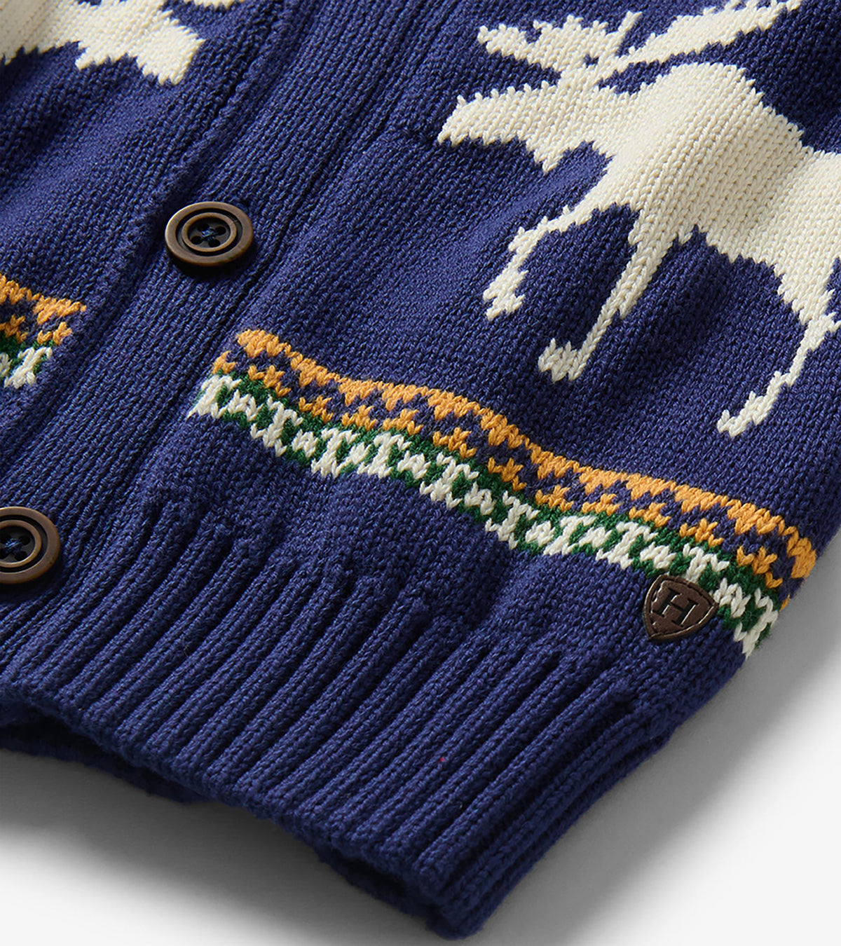Close-up of blue knit cardigan with button front, white moose motif and multicolor striped trim