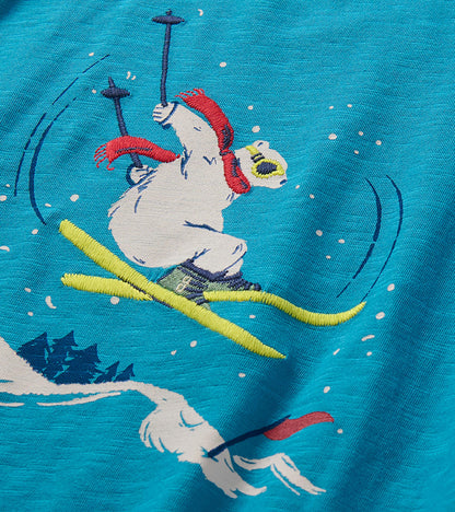 Close-up of bear graphic skiing in a red scarf and goggles on blue shirt
